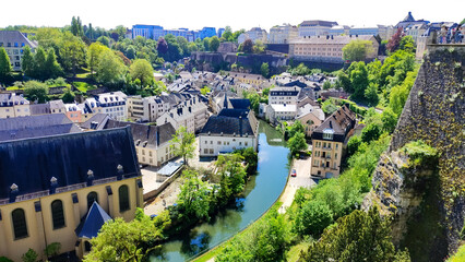 The Walls of the Corniche (Chemin de la Corniche), in Luxembourg. In the ground district, Luxembourg city with the Neumuenster Monastery and the Alzette River Show.