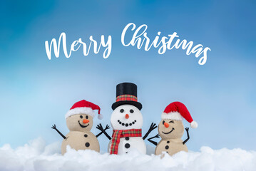A joyful snowman and two sandy snowmen pose together for a Christmas and New Year celebration! With a snowy backdrop and blue sky, this mix of winter and beach vibes brings a fresh holiday twist.