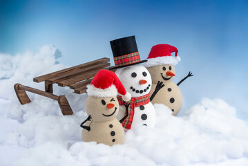 A joyful snowman and two sandy snowmen pose together for a Christmas and New Year celebration.  Lot...