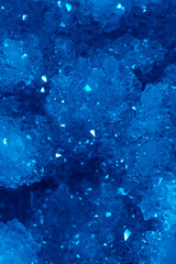 Blue Crystal Mineral Stone. Gems. Mineral crystals in the natural environment. Texture of precious and semiprecious stones. Seamless background with copy space colored shiny surface of precious stones