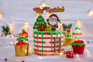 Mesa decorativa con pastel y postres de navidad