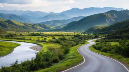 Fototapeta premium Serene Valley Drive, a winding highway meandering through lush landscapes, flanked by a gentle river, creating a peaceful and picturesque escape into nature's beauty.