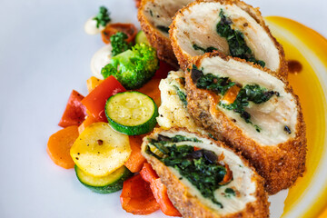 chicken roulade classic with vegetables carrots, potatoes, broccoli, zucchini and cream spinach