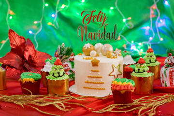 Mesa decorativa con pastel y postres de navidad