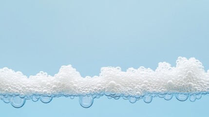 Delicate border of bubble foam floating on clear blue water capturing a clean and refreshing look
