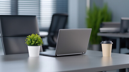 Fototapeta premium Modern workspace with laptop, coffee cup, and potted plant on a desk.
