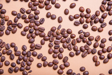 
Top view background of aromatic brown coffee beans scattered on surface
