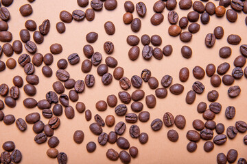 Top view background of aromatic brown coffee beans scattered on surface

