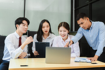 Business team working on a project in the office or reviewing and discussing a business project.