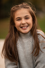 Portrait of a happy child girl looking at camera and smiling.