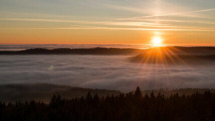 Sunset in the Teplice-Adršpašské rocks. The sun is low on the horizon and the inverted clouds...