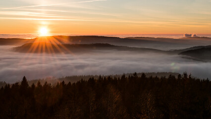Sunset in the Teplice-Adršpašské rocks. The sun is low on the horizon and the inverted clouds create stunning scenery that makes it seem as if you are above the clouds.