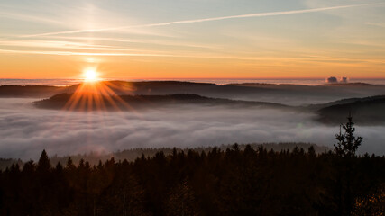 Sunset in the Teplice-Adršpašské rocks. The sun is low on the horizon and the inverted clouds create stunning scenery that makes it seem as if you are above the clouds.