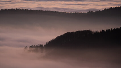 Sunset in the Teplice-Adršpašské rocks. The sun is low on the horizon and the inverted clouds...