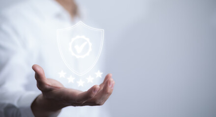 Quality assurance of business services, Businessman Hand shows the sign of the top service Quality assurance in Black background , Guarantee, Standards, ISO certification and standardization concept.