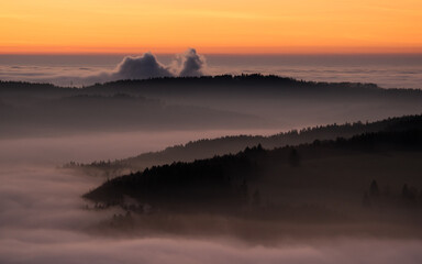 Sunset in the Teplice-Adr&scaron;pa&scaron;sk&eacute; rocks. The sun is low on the horizon and the inverted clouds create stunning scenery that makes it seem as if you are above the clouds.