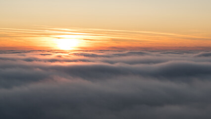 Obraz premium Sunset in the Teplice-Adršpašské rocks. The sun is low on the horizon and the inverted clouds create stunning scenery that makes it seem as if you are above the clouds.