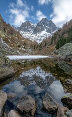 Fototapeta premium Majestic mountain reflected in a calm alpine lake.