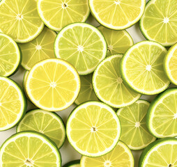 Fresh juicy green lime slices. Texture of sliced ​​citrus fruits. Lime slice patterns. Bright summer style. Flat lay, top view.