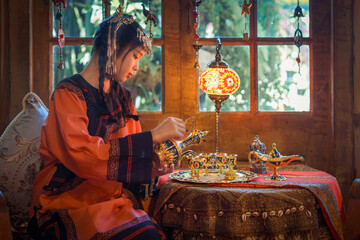 Portrait Fashion of the Asian Tourist young girl wearing traditional Tibetan clothing costume during the Nepal.  Tibetan woman dress concept. Tibetans an East Asian ethnic group native.