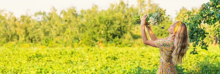 Woman with medicinal herbs in a meadow. Selective focus.