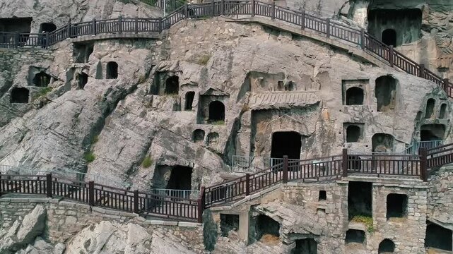 Aerial drone view of Longmen Grottoes Caves Yi River Luoyang in Henan province, China. Chinese Buddhist art Longmen Caves. Longmen Grottoes Caves in Luoyang, China.