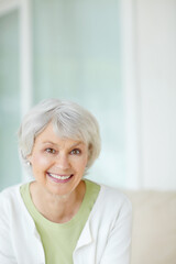 Smile, senior woman and relax on sofa in home living room with care, portrait and retirement break. Happy, elderly pensioner and weekend for rest, confidence and house lounge for person on couch