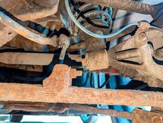 A View Underneath A Vehicle Of It's Suspension With The Underbody A Little Rusty