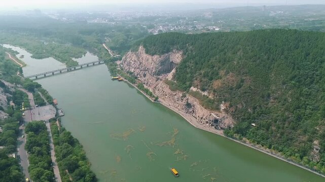 Aerial drone view of Longmen Grottoes Caves Yi River Luoyang in Henan province, China. Chinese Buddhist art Longmen Caves. Longmen Grottoes Caves in Luoyang, China.