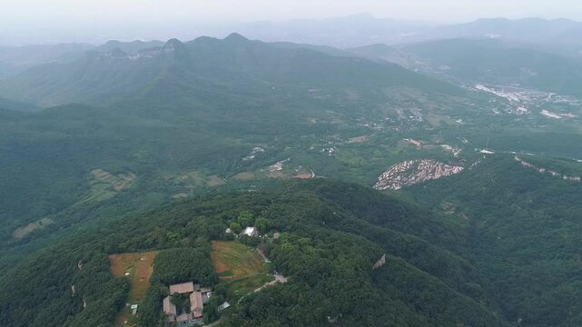 Aerial drone view of Dengfeng color Cableway near Shaolin temple in China. Cable cars run through forest near the Pagoda Forest and Shaolin Temple. Songshan Mountain in Dengfeng City, Henan Province.