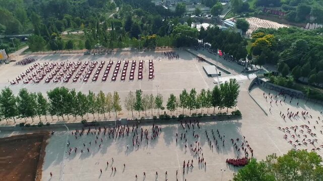 Aerial drone view of Shaolin temple training Martial arts in China. Training Pupils Martial Arts School on the Square. Students practice martial art in Shaolin Temple in Dengfeng city, Henan.