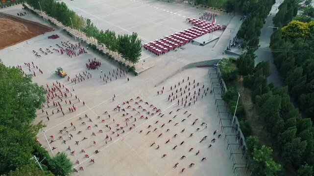 Aerial drone view of Shaolin temple training Martial arts in China. Training Pupils Martial Arts School on the Square. Students practice martial art in Shaolin Temple in Dengfeng city, Henan.