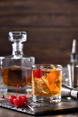 Cocktail Old Fashioned is an old-fashioned sophistication of whiskey and sweet syrup. Served with ice, orange zest and Maraschino cherry. 