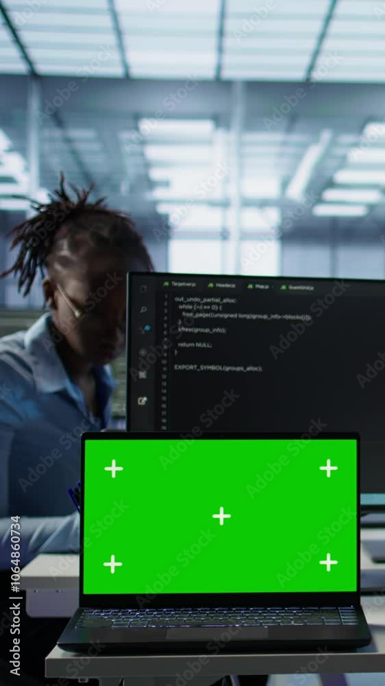 Poster isolated screen laptop next to programmer coding in server farm while listening music in headphones.