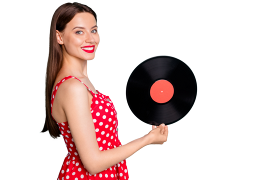 Portrait of lovely girl holding vinyl record disc smiling wearing dotted dresss skirt isolated over green teal turquoise background