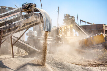 Vibrating screen stone crusher in operation. Crushing stones in a quarry for processing minerals,...