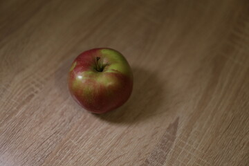 red apple on wooden table