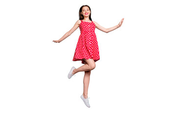 Full size photo of lovely girl smiling jumping wearing polka dot skirt dress isolated over teal turquoise background