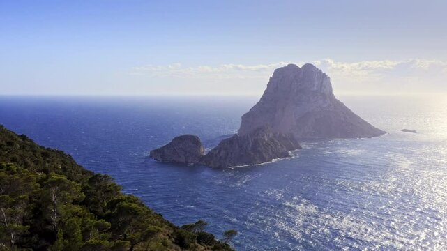 Ibiza's Iconic Es Vedra with Mediterranean Coastline &ndash; Aerial View of Island Formation and Ibiza'sIbiza's Iconic Es Vedra with Mediterranean Co Scenic Shores in Deep Blue Waters &ndash; Drone Tracking Right
