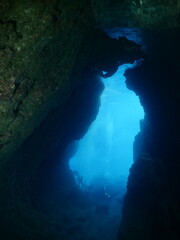 cave diving underwater scuba divers exploring reefs and caves