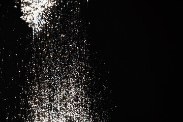 Abstract black and white background of pouring flour, space for text