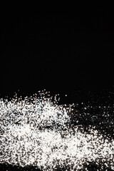Abstract black and white background of pouring flour, space for text