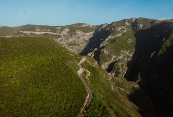 Scenic view of a winding road through lush mountains in Armenia during daylight hours