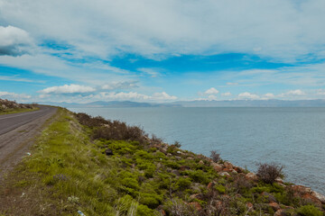 Scenic view along the coastline with lush greenery and distant mountains in Armenia