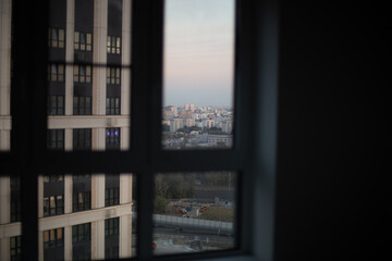 Obraz premium City view through window with soft evening light, urban skyline and minimal interior concept 