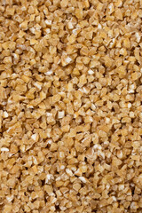 Background of raw uncooked wheat groats, macro top view