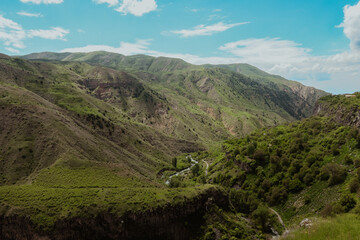 A breathtaking view of Armenian mountains and lush green valleys under a clear blue sky