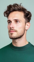 Obraz premium A man with a beard and a green shirt