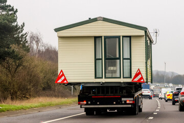 A Lorry Carrying A Static Caravan Home To It's Next Location And New Customer
