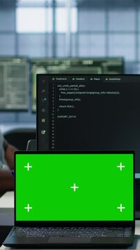 Diverse team of developers in server hub using green screen laptop, looking for misconfigurations. African american IT experts mending data center bugs with chroma key notebook, camera A
